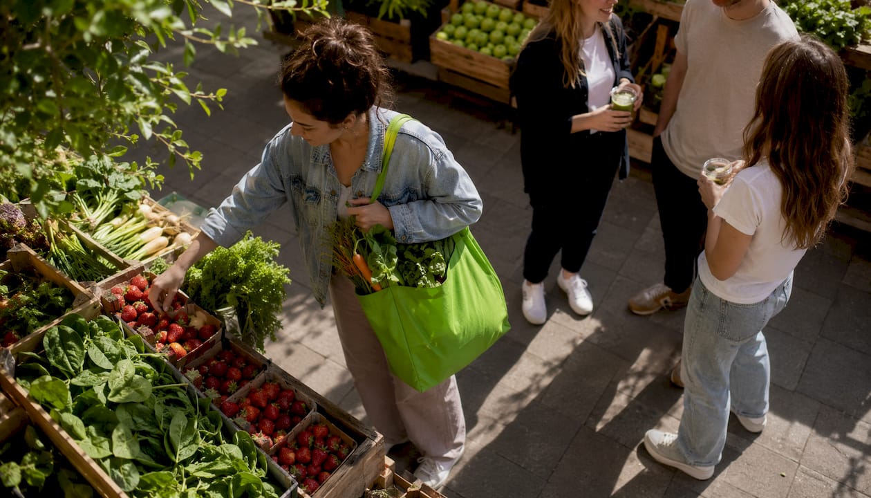 Woman selecting organic produce at market