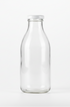 A clean, transparent glass milk bottle standing upright on a plain white background. No label, no text, no branding. The bottle should have a simple shape similar to classic dairy bottles, with a smooth surface and a white cap. Well-lit, high-resolution product-style photograph.